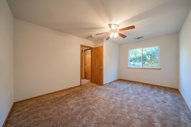 unfurnished room with ceiling fan, carpet floors, and a textured ceiling