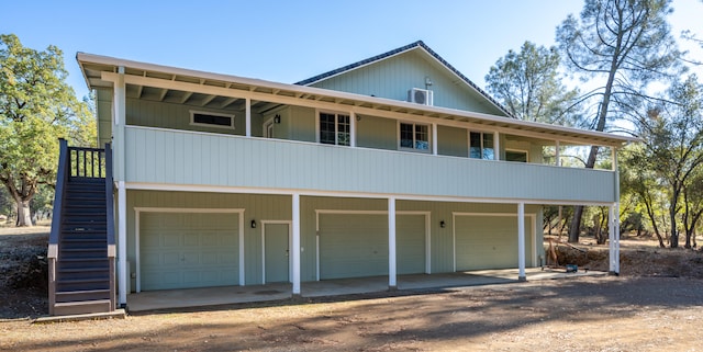 view of front facade featuring a garage and a balcony