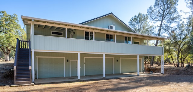 view of front facade with a garage and a balcony