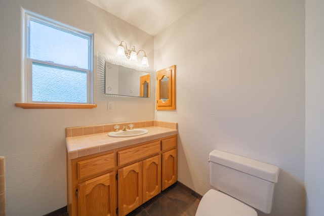 bathroom featuring tile patterned floors, vanity, and toilet