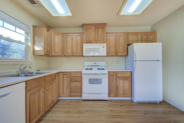 kitchen with white appliances, light hardwood / wood-style flooring, and sink