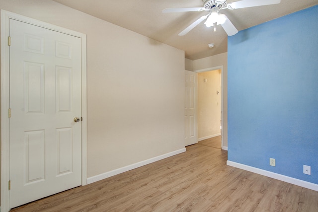 empty room featuring ceiling fan and light hardwood / wood-style flooring