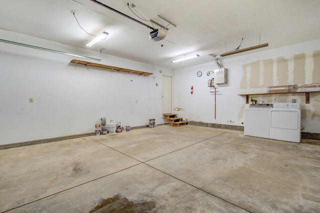 garage featuring washer and dryer and a garage door opener