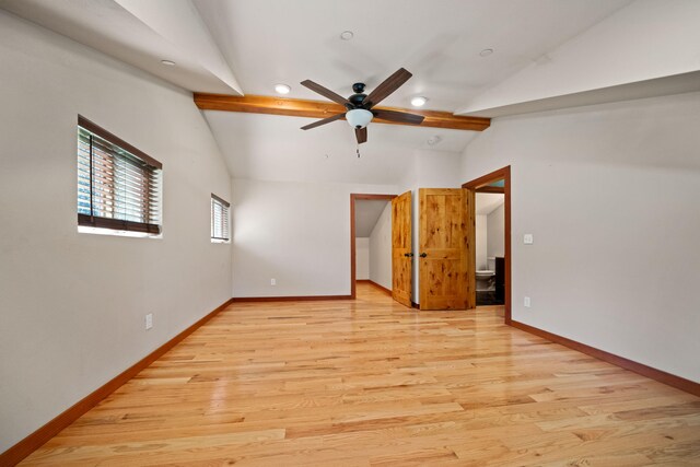 empty room featuring vaulted ceiling with beams, ceiling fan, and light wood-type flooring