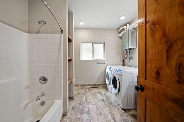 bathroom with tankless water heater, separate washer and dryer, and tiled shower / bath