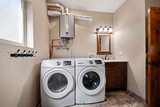 washroom with separate washer and dryer, water heater, sink, and cabinets