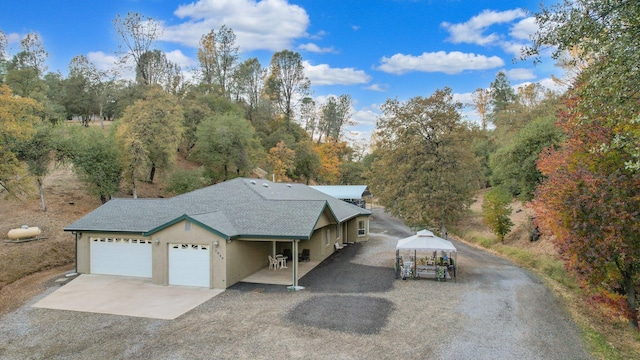 view of front of house featuring a garage and a gazebo