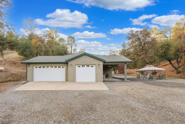 single story home with a garage, a gazebo, and a carport