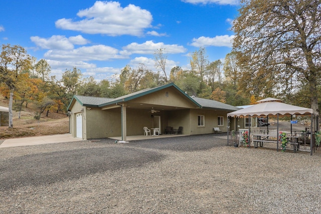 ranch-style home featuring a garage and a gazebo