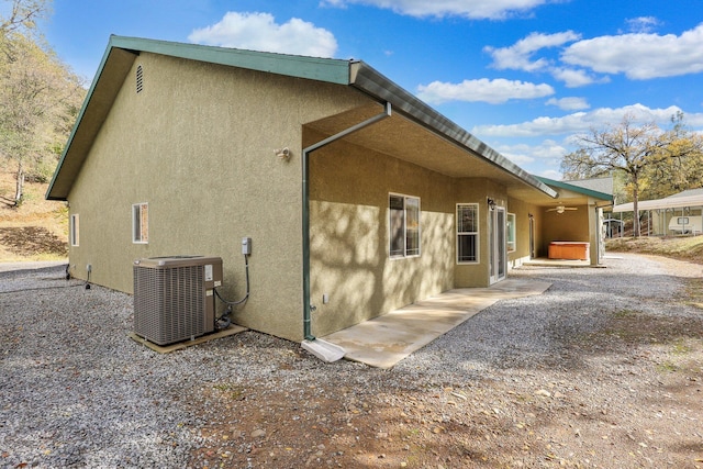 view of home's exterior featuring a patio area and cooling unit