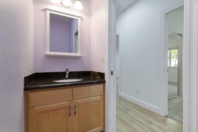 bathroom with hardwood / wood-style floors and vanity