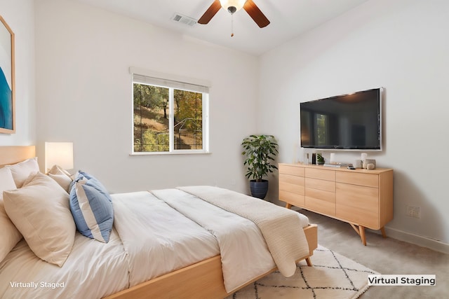 bedroom featuring light carpet and ceiling fan