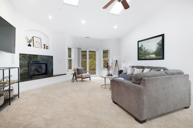 carpeted living room with ceiling fan and high vaulted ceiling