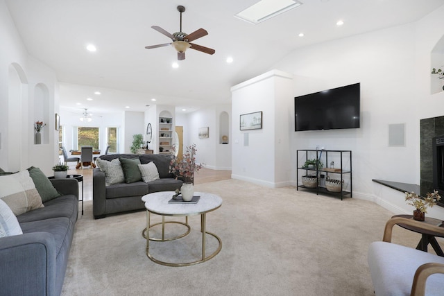 carpeted living room with ceiling fan