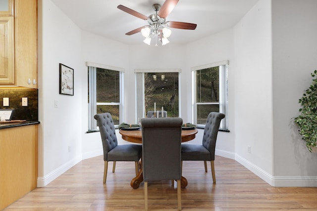 dining room with ceiling fan and light hardwood / wood-style flooring