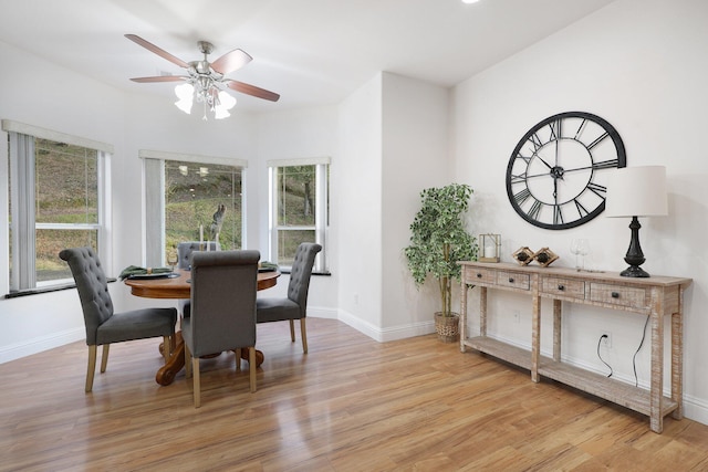 dining area with ceiling fan and light wood-type flooring