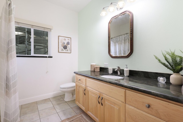 bathroom with tile patterned floors, vanity, and toilet