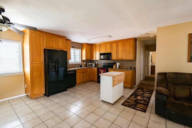 kitchen with black appliances, ceiling fan, light tile patterned floors, and sink