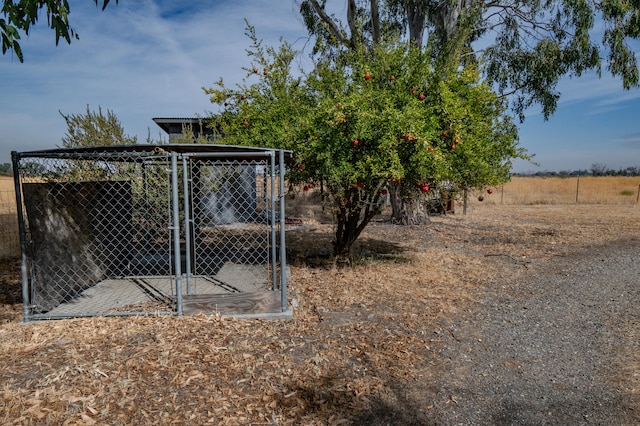 view of yard with an outbuilding and a rural view