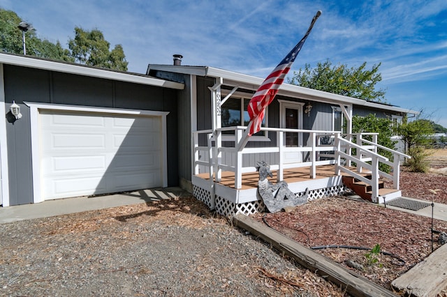 ranch-style home featuring a porch and a garage