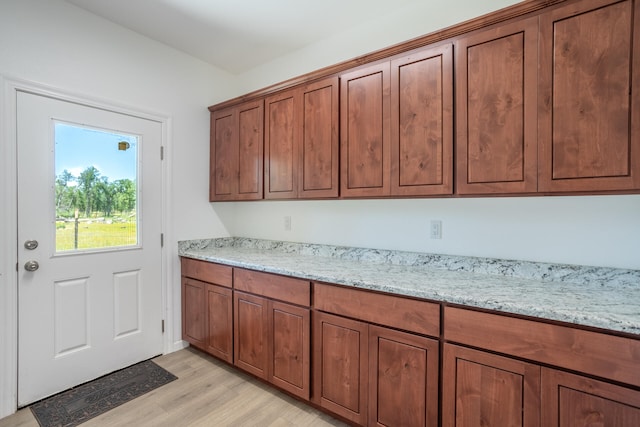 kitchen featuring light hardwood / wood-style floors and light stone countertops