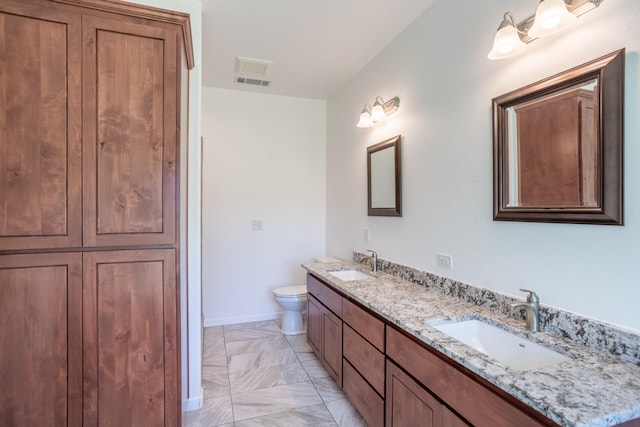 bathroom with vanity and toilet