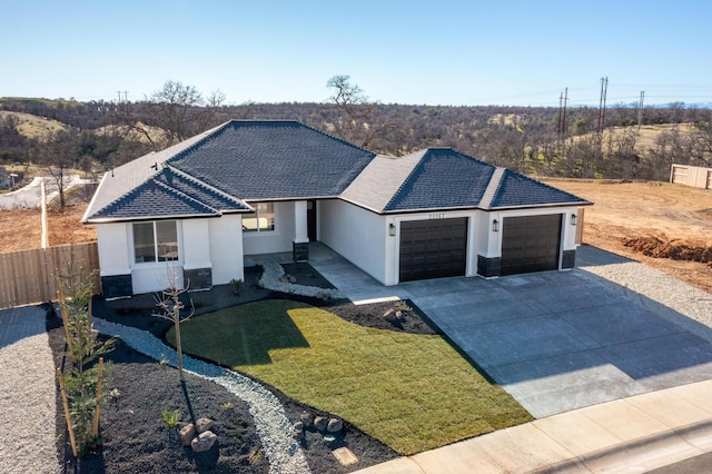 view of front facade with a garage and a front lawn