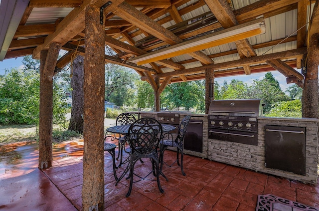 view of patio featuring a gazebo, grilling area, and exterior kitchen