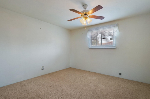 unfurnished room with ceiling fan and carpet