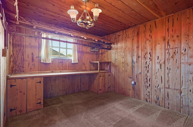 basement with dark colored carpet, wooden ceiling, an inviting chandelier, and wooden walls