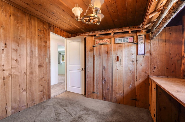 hallway with wooden ceiling, carpet floors, wooden walls, and an inviting chandelier