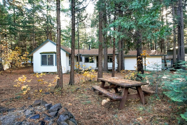 view of front of property featuring a porch and a garage