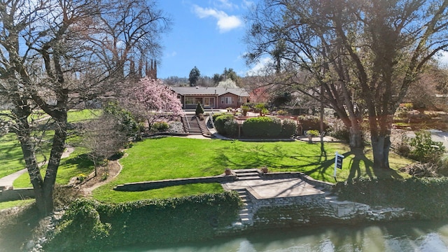 surrounding community with a yard, a deck, and stairs