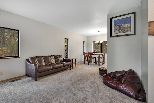 living room with carpet flooring and a chandelier