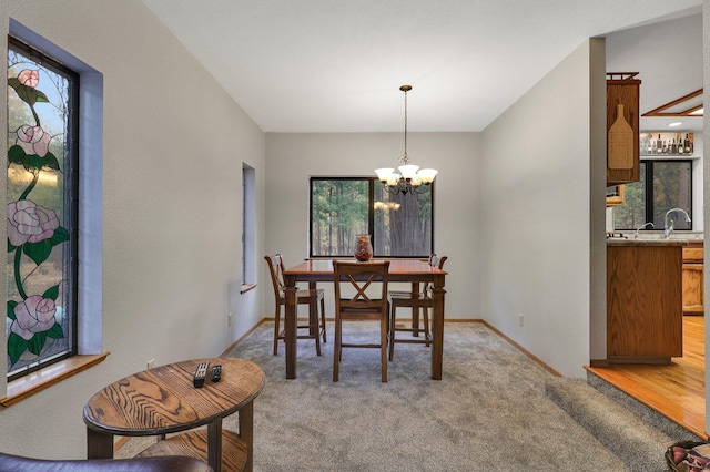 carpeted dining room with a notable chandelier