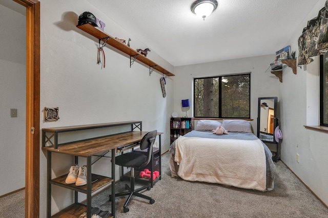 carpeted bedroom featuring a textured ceiling