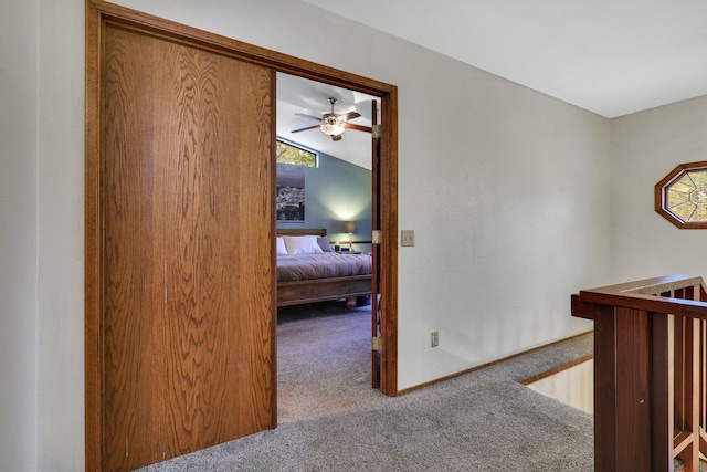 hall with carpet flooring and vaulted ceiling