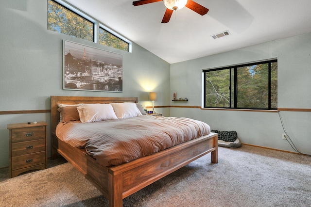 carpeted bedroom with ceiling fan and vaulted ceiling