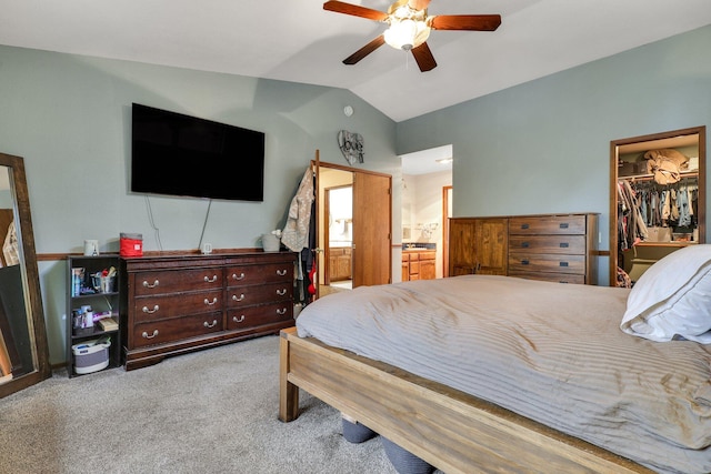 bedroom featuring a walk in closet, ensuite bath, ceiling fan, a closet, and lofted ceiling