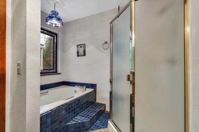 bathroom featuring tile patterned flooring and independent shower and bath