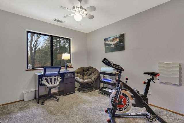 carpeted office featuring ceiling fan