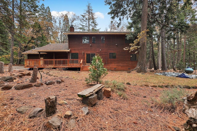 rear view of house featuring a wooden deck