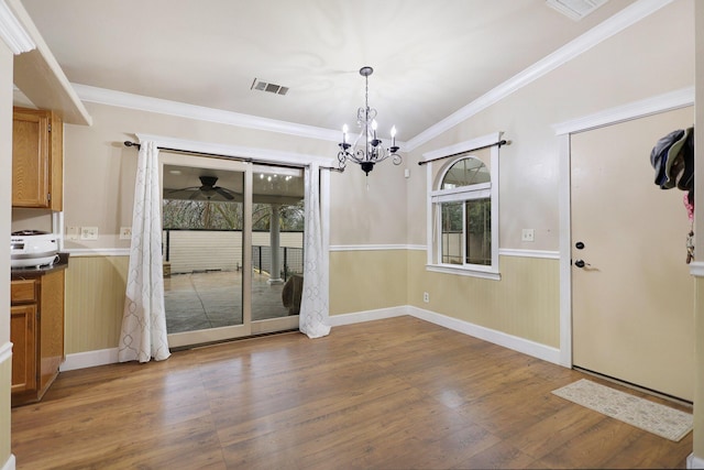 unfurnished dining area featuring crown molding, lofted ceiling, and hardwood / wood-style flooring