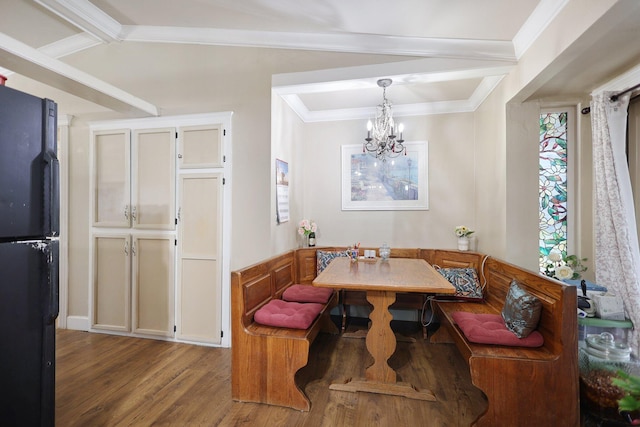 dining space featuring breakfast area, ornamental molding, beam ceiling, hardwood / wood-style flooring, and an inviting chandelier