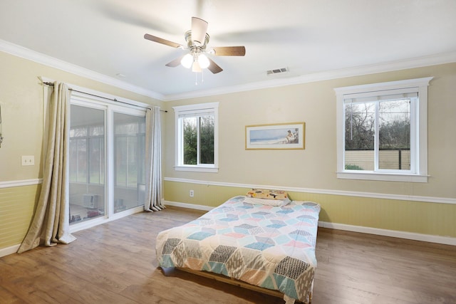 bedroom featuring hardwood / wood-style floors, access to outside, ceiling fan, and crown molding