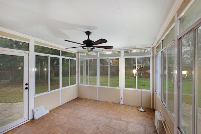 unfurnished sunroom with a wall mounted air conditioner and ceiling fan