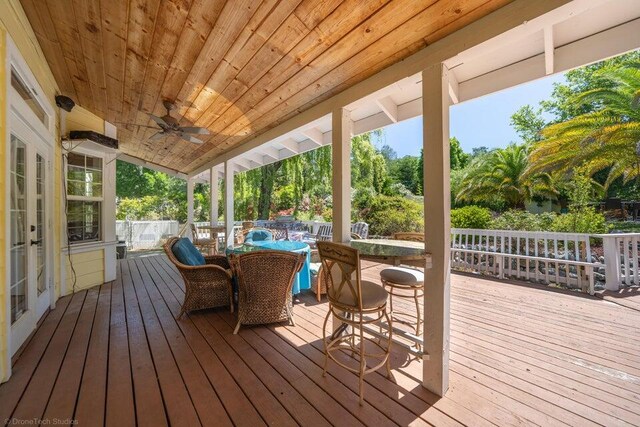 wooden deck featuring ceiling fan