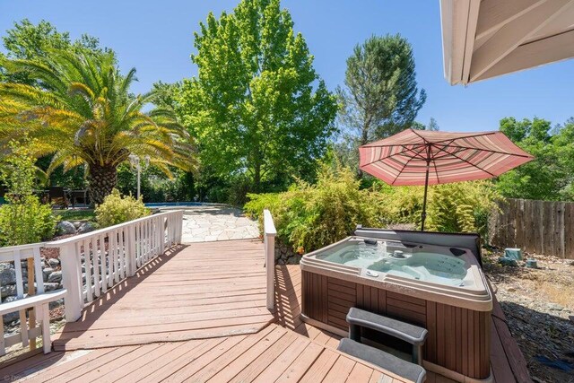 wooden terrace with a hot tub