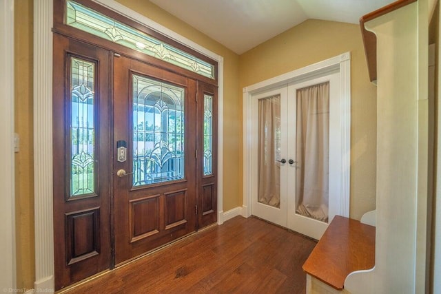 foyer entrance featuring lofted ceiling, french doors, and dark hardwood / wood-style floors