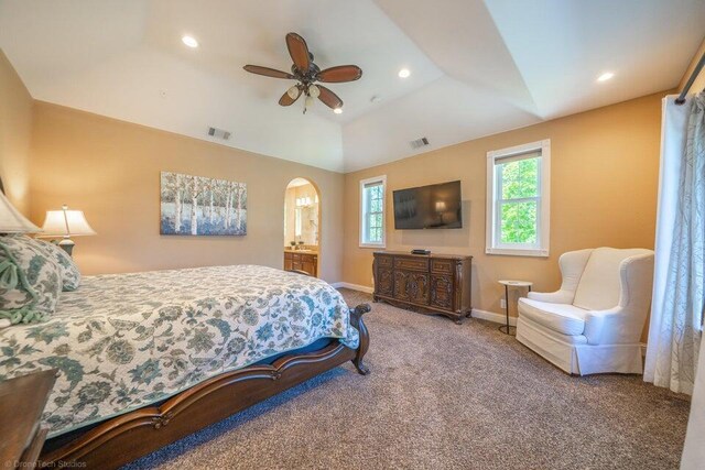 bedroom featuring a raised ceiling, ceiling fan, carpet floors, and vaulted ceiling